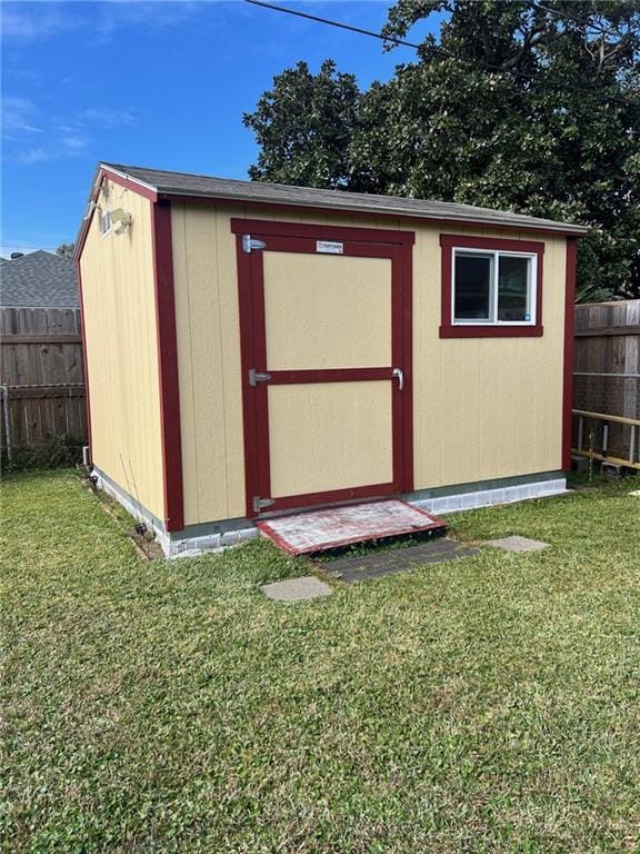 view of outbuilding with a yard