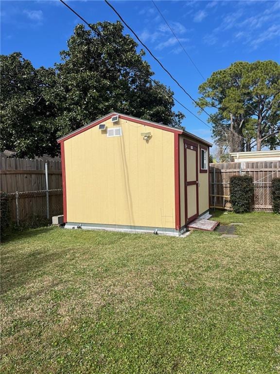 view of outbuilding featuring a lawn