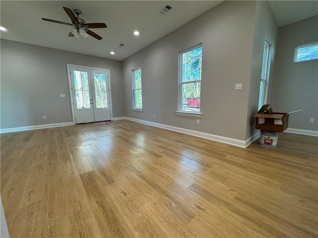 empty room featuring french doors, ceiling fan, and light hardwood / wood-style floors