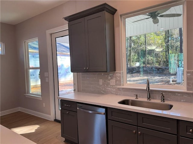 kitchen with plenty of natural light, stainless steel dishwasher, ceiling fan, and sink