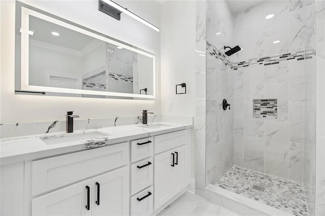 bathroom featuring a tile shower, crown molding, and vanity