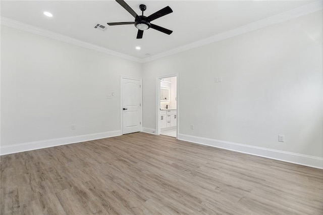 empty room featuring ceiling fan, light hardwood / wood-style floors, and crown molding