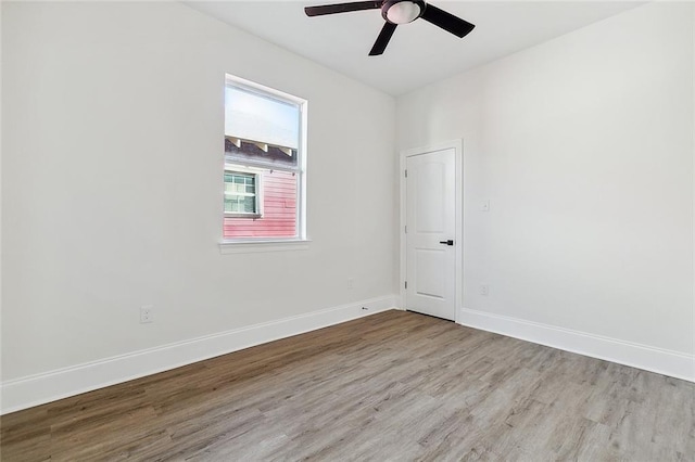 spare room with ceiling fan and light wood-type flooring