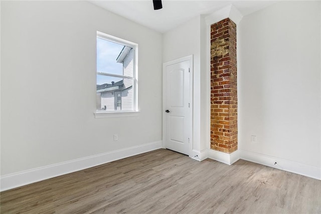 empty room featuring ceiling fan and light wood-type flooring