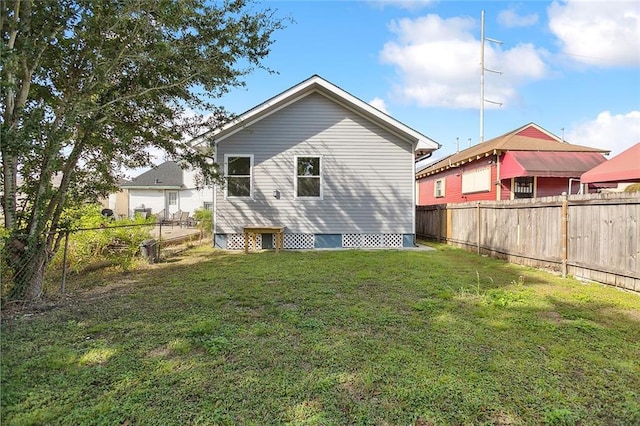 back of property featuring a lawn