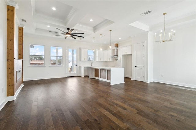 unfurnished living room with coffered ceiling, ornamental molding, dark hardwood / wood-style flooring, beamed ceiling, and ceiling fan with notable chandelier