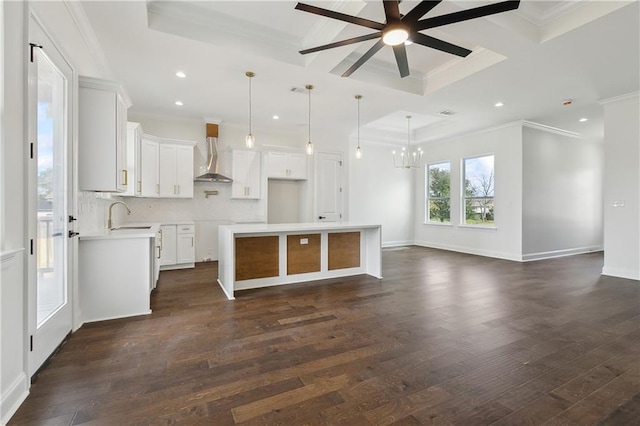 kitchen featuring pendant lighting, white cabinets, dark hardwood / wood-style flooring, a center island, and wall chimney exhaust hood