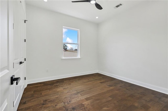 spare room with dark wood-type flooring and ceiling fan