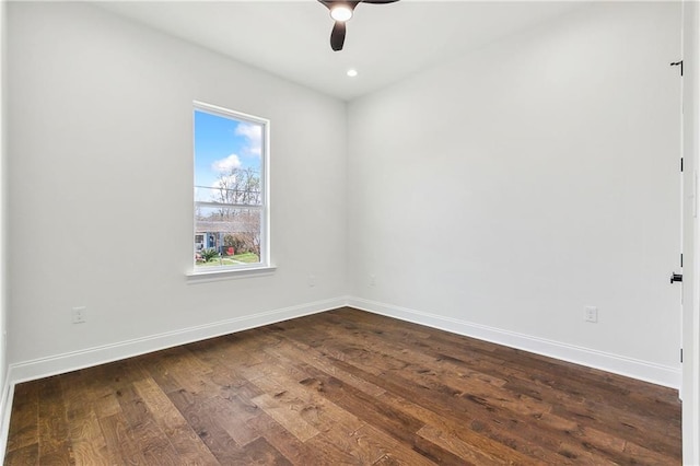 empty room with ceiling fan and dark hardwood / wood-style flooring