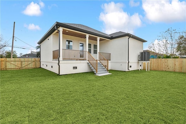 rear view of house with a porch and a yard