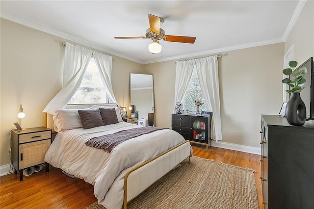 bedroom featuring ceiling fan, crown molding, and hardwood / wood-style floors