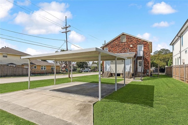 view of parking featuring a carport and a lawn