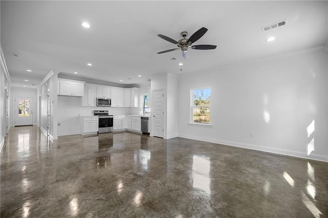 unfurnished living room with ceiling fan, a healthy amount of sunlight, and crown molding