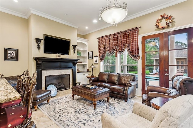 tiled living room featuring a tiled fireplace, french doors, and crown molding