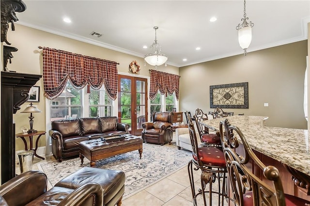 living room with crown molding, french doors, and light tile patterned floors