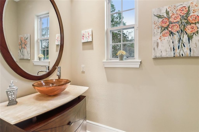 bathroom featuring a healthy amount of sunlight and vanity