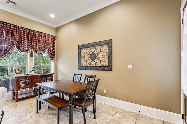 tiled dining room featuring ornamental molding