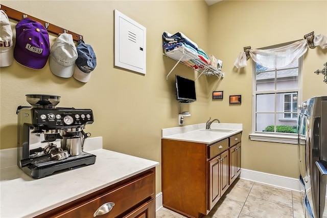 bathroom featuring tile patterned flooring, washer / clothes dryer, and vanity