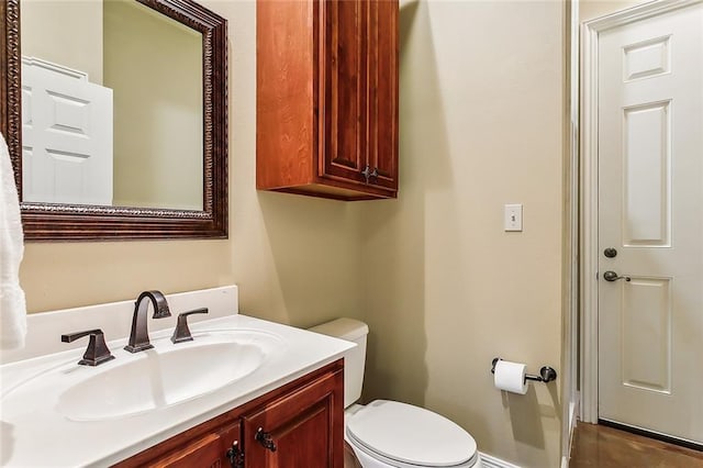 bathroom with toilet and vanity