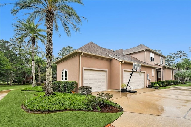 view of front of house with a front yard and a garage