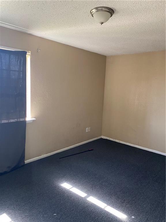 151 Pinewood Ct, New Orleans, LA 70114 - empty room with carpet floors and a textured ceiling