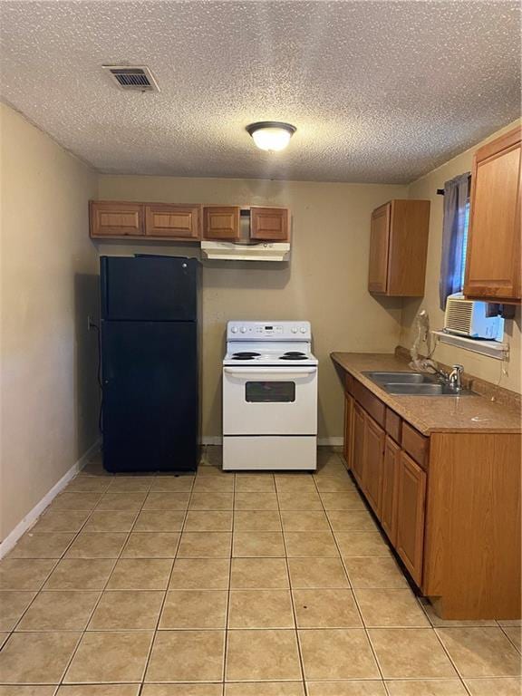 151 Pinewood Ct, New Orleans, LA 70114 - kitchen featuring freestanding refrigerator, white range with electric stovetop, a sink, a textured ceiling, and light tile patterned floors