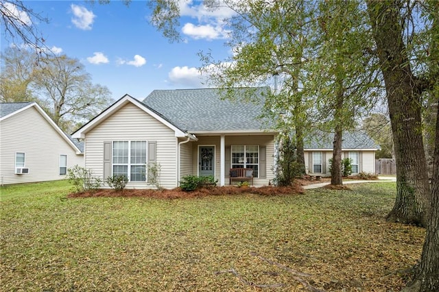 single story home featuring covered porch and a front lawn