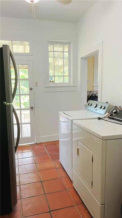 washroom featuring light tile patterned floors, laundry area, and washer and dryer