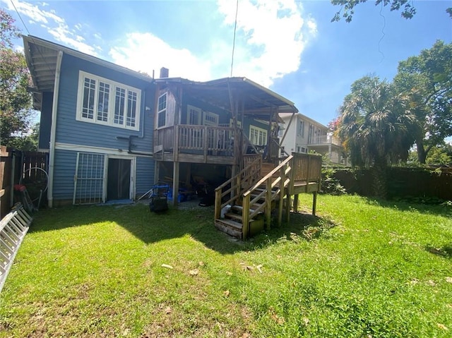 rear view of property featuring fence private yard, stairs, a lawn, and a wooden deck