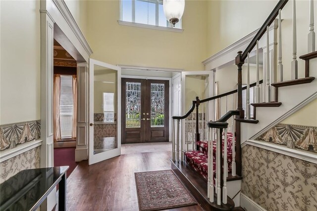 foyer entrance featuring french doors and dark hardwood / wood-style flooring