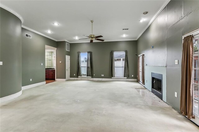 unfurnished living room featuring ceiling fan and ornamental molding