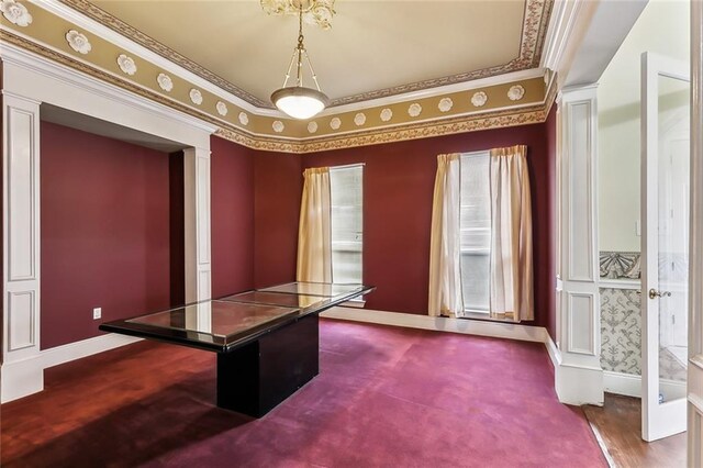 unfurnished office featuring crown molding and carpet flooring