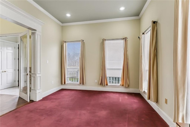 carpeted spare room with crown molding