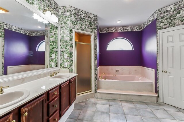 bathroom with shower with separate bathtub, vanity, and tile patterned floors