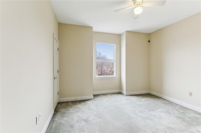 unfurnished room with ceiling fan and light colored carpet