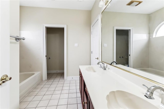 bathroom featuring a bath, tile patterned flooring, and vanity