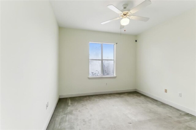 spare room with ceiling fan and carpet floors