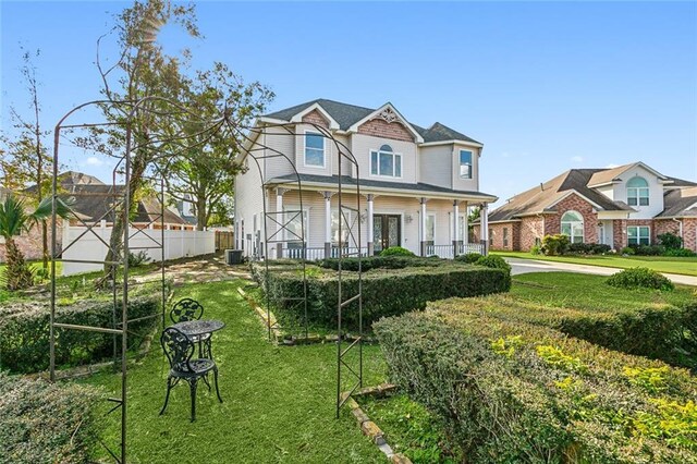 view of front of home featuring a front yard and covered porch