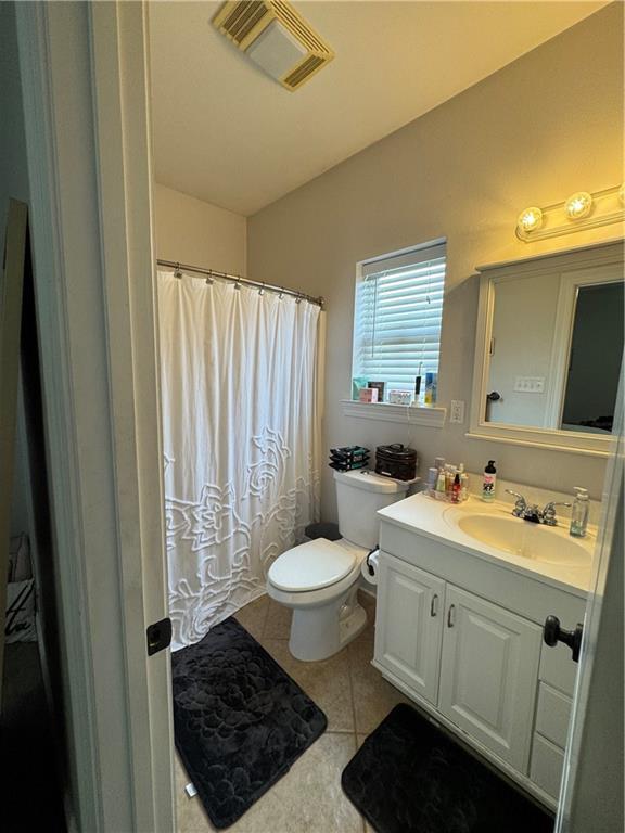 bathroom with vanity, tile patterned floors, and toilet