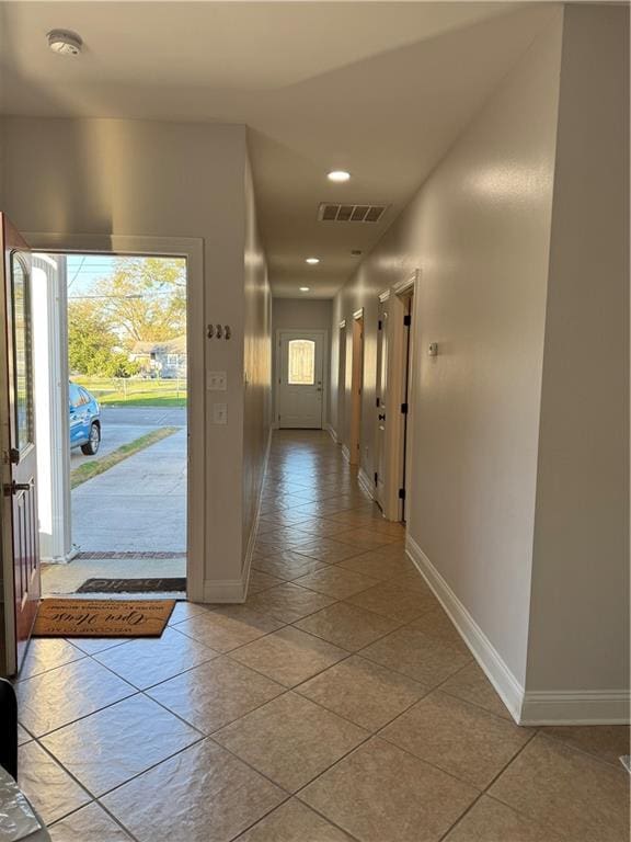 hallway featuring light tile patterned floors