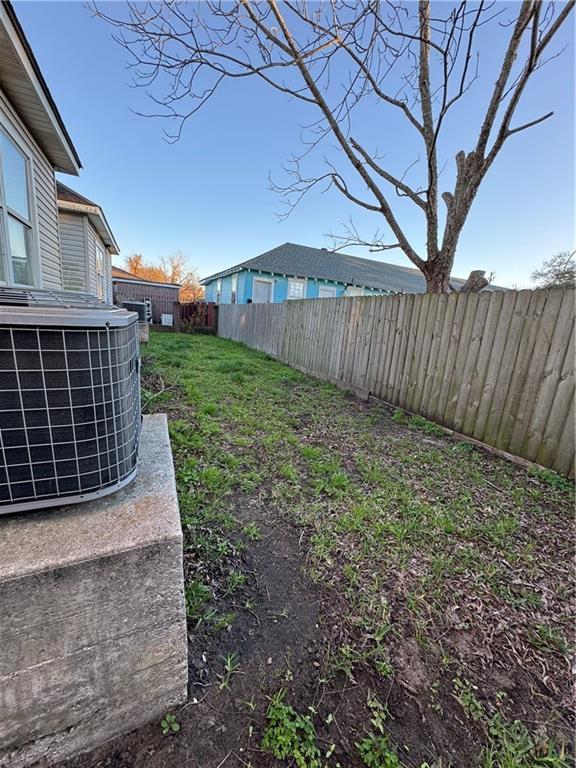 view of yard featuring central air condition unit