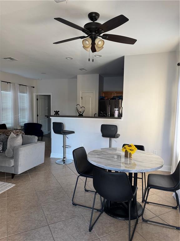 dining room featuring ceiling fan and light tile patterned floors