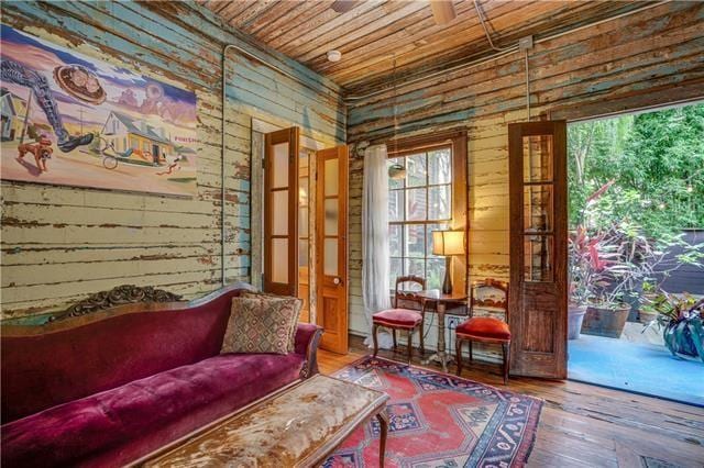 living area featuring hardwood / wood-style flooring and wooden ceiling