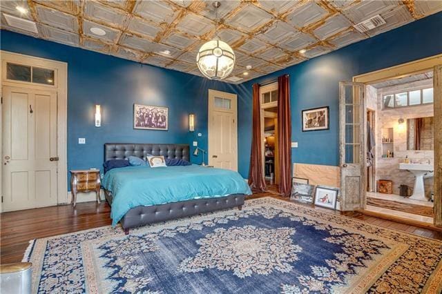 bedroom with coffered ceiling and wood-type flooring