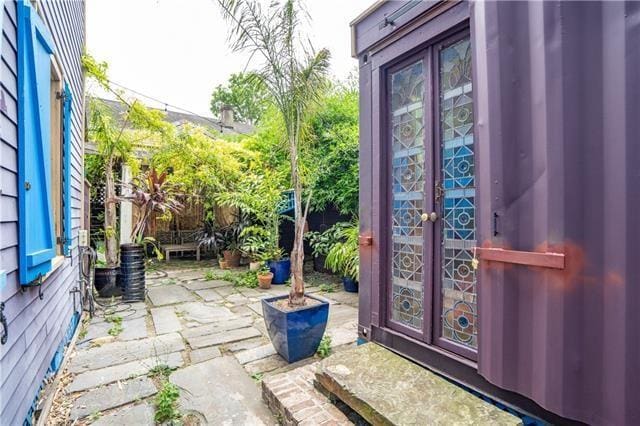 entrance to property featuring a patio area and french doors