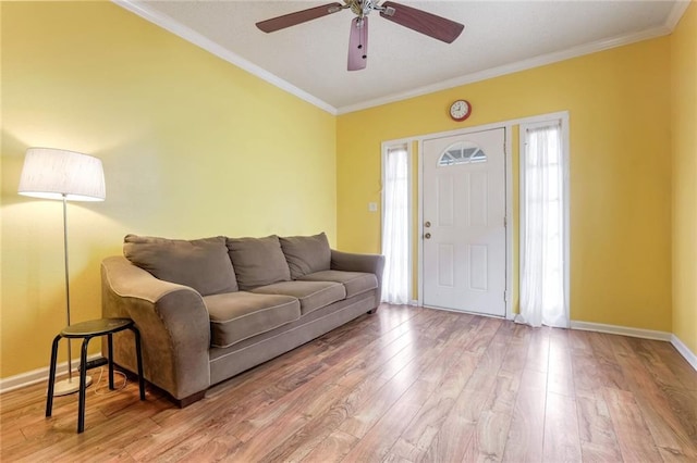 living room with ornamental molding, ceiling fan, and hardwood / wood-style floors