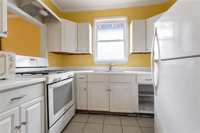 kitchen with white appliances, light tile patterned floors, ornamental molding, white cabinets, and sink