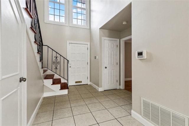 tiled foyer entrance with a high ceiling