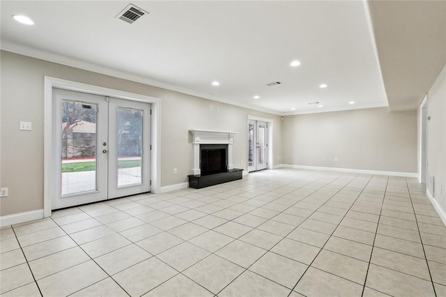 unfurnished living room with ornamental molding, french doors, and light tile patterned flooring