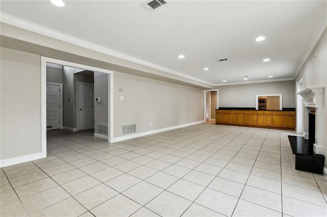 unfurnished living room featuring ornamental molding and light tile patterned floors